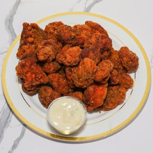 Boneless Buffalo wings with dipping sauce at Destinis